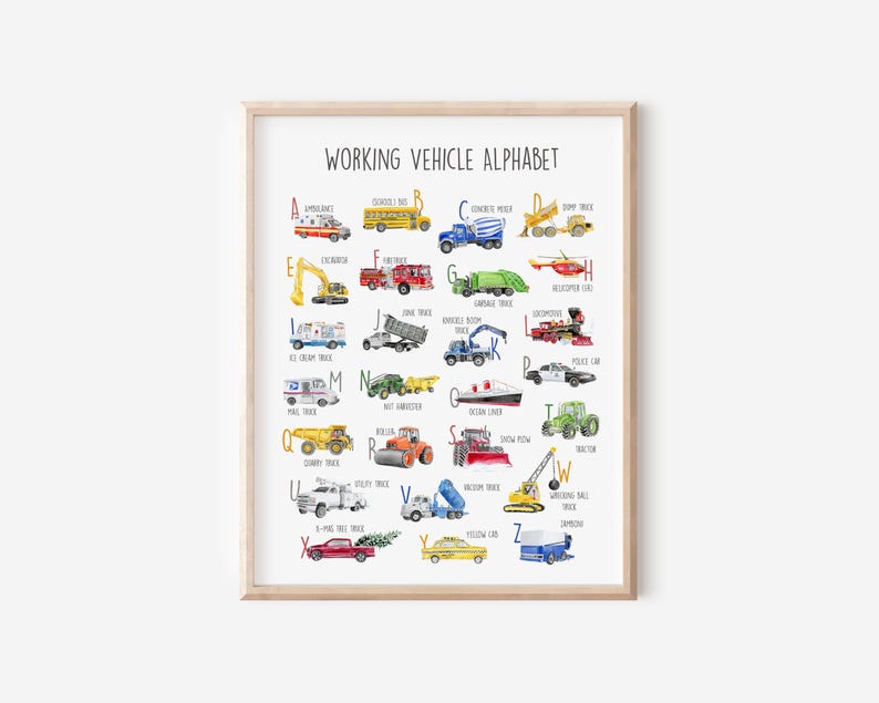 May include: A framed print featuring a watercolor illustration of a working vehicle alphabet. Each letter showcases a different vehicle, including an ambulance, school bus, concrete mixer, and dump truck. The print is in a light wood frame.