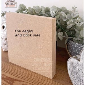May include: A light brown, rectangular wooden block with the text "the edges and back side" printed on the front. The block is positioned on a wooden surface, with greenery and a decorative item in the background. The block has the Chestnut Wood Craft B&J Workshop logo.