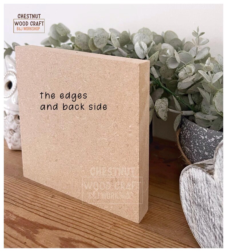 May include: A light brown, rectangular wooden block with the text "the edges and back side" printed on the front. The block is positioned on a wooden surface, with greenery and a decorative item in the background. The block has the Chestnut Wood Craft B&J Workshop logo.