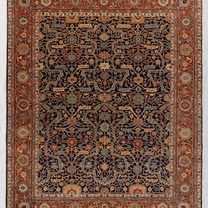 May include: A large, rectangular rug with an intricate, floral pattern. The rug features a dark navy blue field with a complex design in shades of rust, teal, and gold. A wide border in rust-red frames the central design, adding a contrasting element.