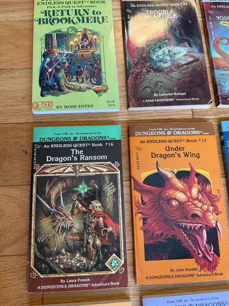 May include: A collection of vintage fantasy adventure books, including titles like "Return to Brookmere" and "The Dragon's Ransom." The books feature colorful covers with illustrations of dragons, warriors, and other fantasy elements. The books are from the "Dungeons & Dragons" and "Endless Quest" series.