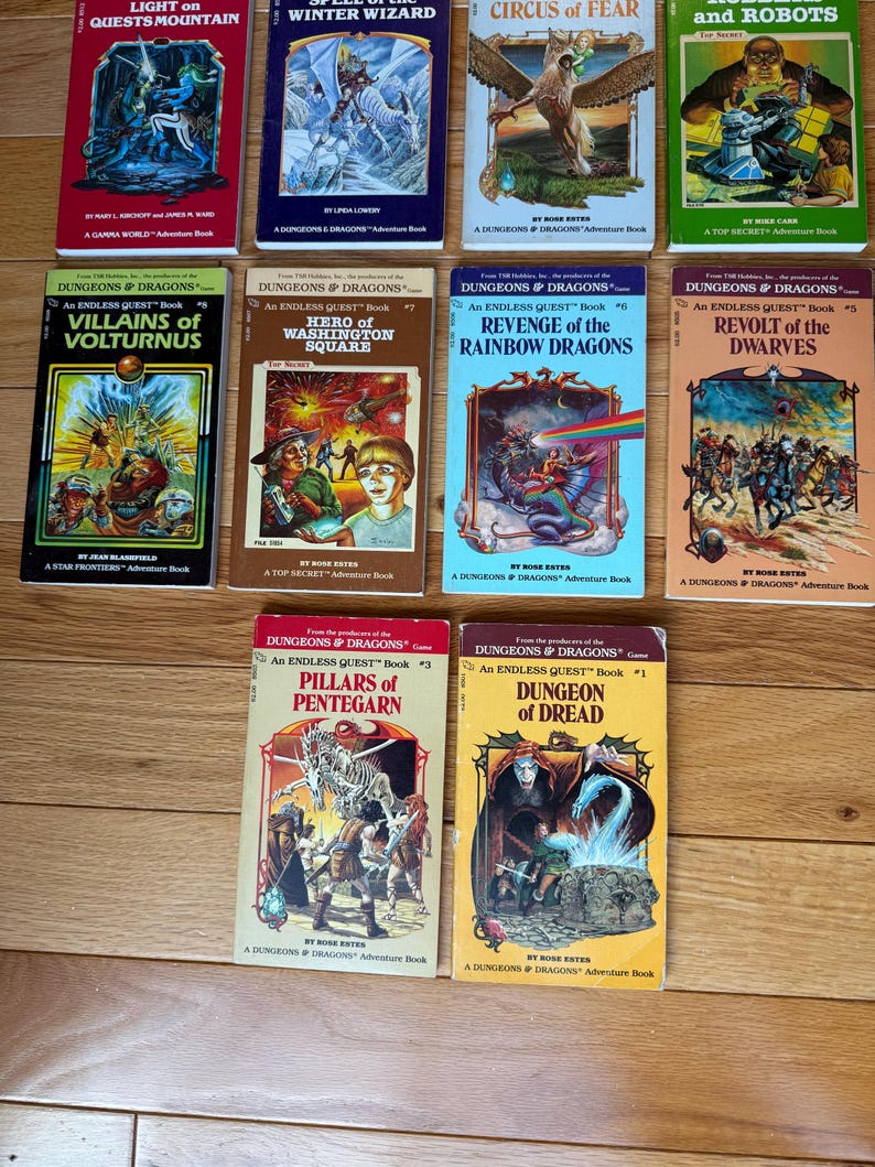 May include: A collection of vintage "Dungeons & Dragons" adventure books. The covers feature colorful illustrations of fantasy scenes, including dragons, wizards, and warriors. Titles include "Light on Quests Mountain" and "Dungeon of Dread."