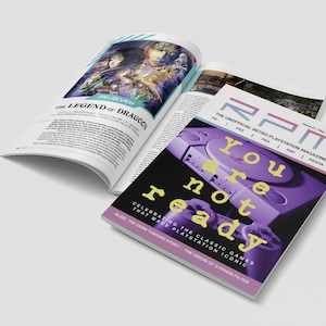 Könnte beinhalten: Ein Magazincover mit dem Titel "RPM: The Unofficial Retro Playstation Magazine" und dem Text "You are not ready" in gelben Buchstaben auf einem violetten Hintergrund. Das Cover zeigt eine violette Playstation-Konsole.