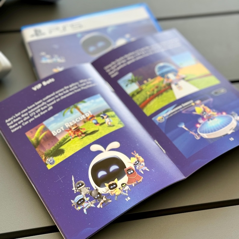 May include: An open booklet with a purple cover and a blue background. The booklet features a cartoon character with a white body and a black face. The character is surrounded by other cartoon characters. The text "Bot Rescued!" is visible in the image.