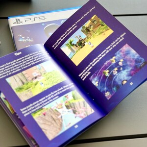 May include: A purple and blue booklet with the title "Tips" and images of a video game. The text reads "Hi everything! There are hidden items in trees and wires to pull that reveal coins chests and puzzle pieces."
