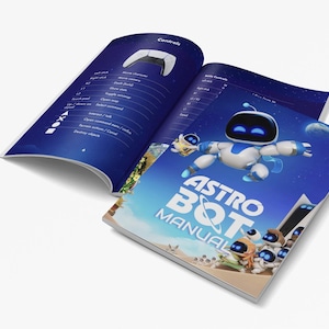 May include: A blue and white Astro Bot game manual with a cartoon robot on the cover. The manual has the title "Astro Bot Manual" in white text on a blue background.