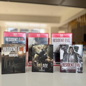May include: A collection of video game cases and manuals. The red game cases display "RESIDENT EVIL". The manuals feature the game titles "biohazard", "VILLAGE", and "requiem". The games are for the Nintendo Switch.
