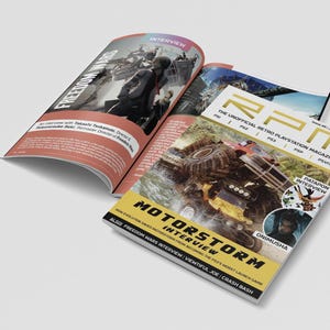 May include: An open magazine with a cover showing a monster truck in a muddy setting. The magazine is titled "RPM" and includes the text "MOTORSTORM INTERVIEW". The open page features an interview titled "FREEDOM WARS".