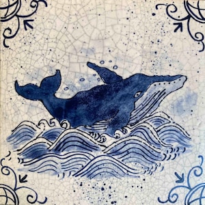 May include: A blue whale breaching out of the water, with blue waves and white foam. The whale is silhouetted against a white background with blue speckles.