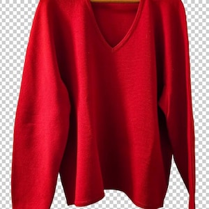 May include: A solid bright red long-sleeve sweater featuring a deep V-neckline and a straight hem. The garment is displayed on a wooden hanger and includes a small rectangular brand label stitched inside the center of the neckline collar.