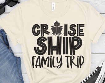 May include: A beige t-shirt with black text that reads "Cruise Ship Family Trip". The text is in a retro font style. A small black silhouette of a cruise ship is above the word "Cruise".