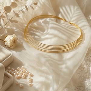 May include: A rustic wooden sign with the text "Welcome" in a handwritten style. The sign is painted white with a distressed finish, and features a decorative floral element in the corner. The background is a blurred image of a wooden surface.