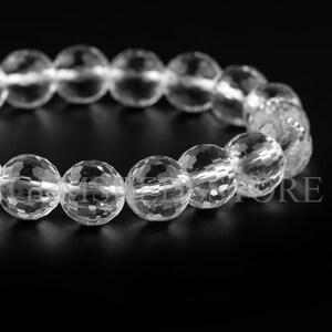 May include: A clear crystal bracelet with faceted beads. The bracelet is made of natural quartz and is designed to be worn on the wrist.