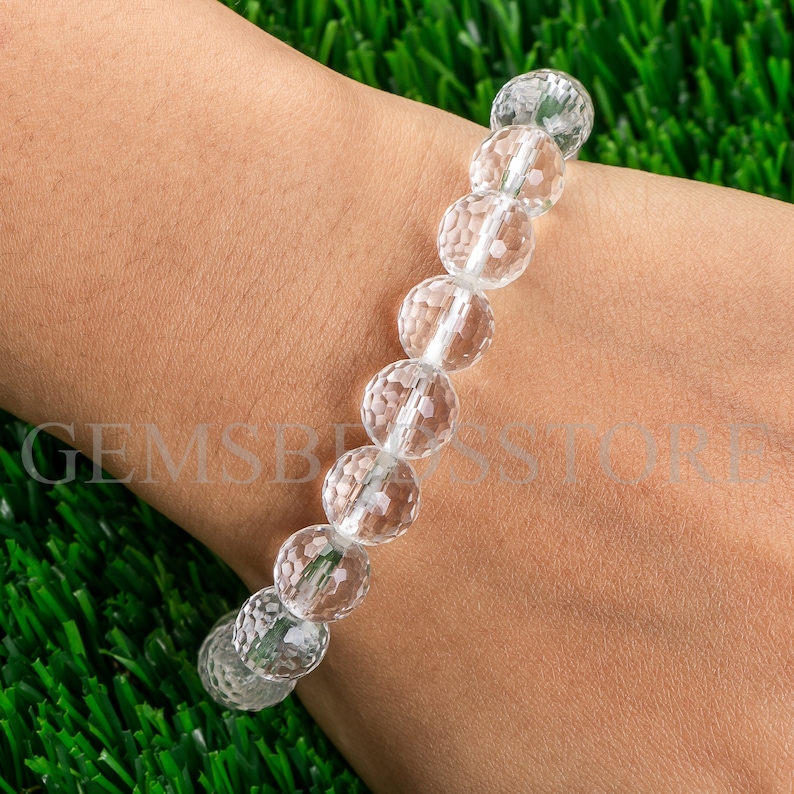 May include: A clear crystal bracelet with faceted beads. The bracelet is made of natural crystal and is designed to be worn on the wrist.