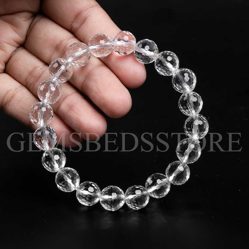 May include: A clear crystal bracelet with faceted beads. The bracelet is made of natural quartz and is approximately 7 inches in length.