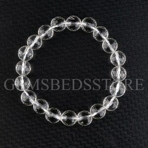 May include: A clear crystal bracelet with faceted beads. The bracelet is made of natural quartz and is approximately 7 inches in length.