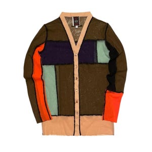 May include: A long-sleeve V-neck cardigan featuring a sheer mesh construction with a color-blocked patchwork design in olive green, dark purple, light mint green, bright orange, black, and a light peach trim along the button placket and hem.