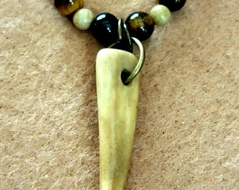 Antler point: Brown tiger eye, Jasper, Agate, bone and seed.