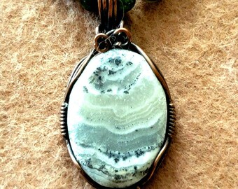 Silver lace onyx pendent with Picasso Jasper, Jade, bone and shell.