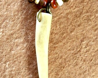 Antler point: red tiger eye, fire agate, carnelian, bone and shell