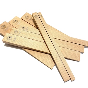 May include: A set of eight wooden shims in various sizes, all with the same logo printed on them. The logo is a circle with the text "Large Size" and "2.5mm" inside.
