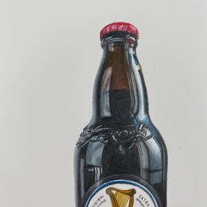 May include: A dark brown Guinness stout beer bottle with a red cap. The bottle has a white label with a gold harp and the Guinness logo. The words "The Original" and "Extra Stout" are also visible.