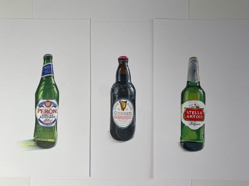 May include: Three beer bottles: Peroni, Guinness, and Stella Artois, each with its distinct label. The Peroni bottle is green with a blue and white label. The Guinness bottle is dark with a white label. The Stella Artois bottle is green with a red and white label.