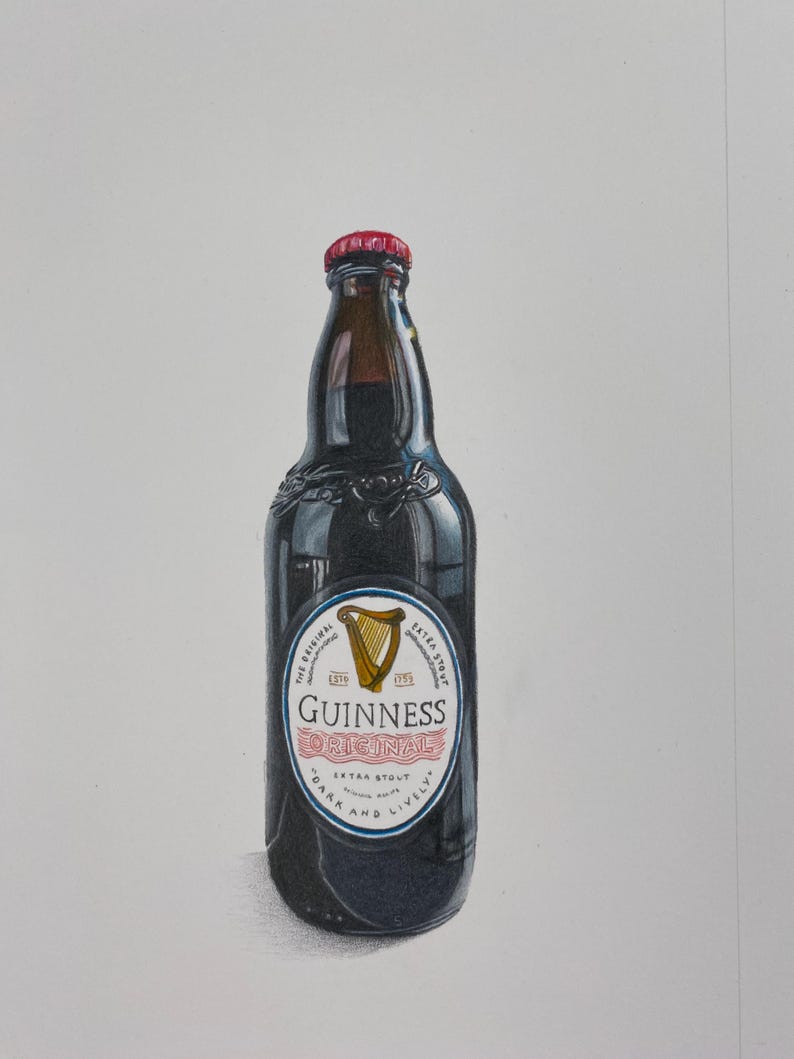 May include: A dark glass Guinness beer bottle with a red cap. The label features a gold harp and the words "Guinness Original Extra Stout". The bottle is filled with a dark liquid.