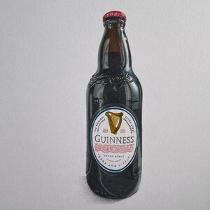 May include: A dark brown Guinness Original stout beer bottle with a red cap. The label features a gold harp and the text "Guinness Original Extra Stout Dark and Lively."