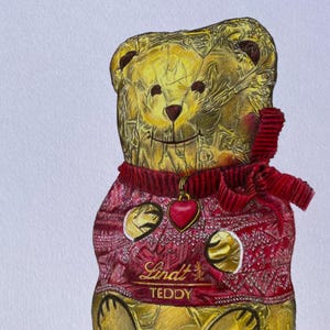 Puede incluir: Ilustraci&oacute;n detallada de un oso de peluche Lindt. El oso est&aacute; envuelto en papel dorado y lleva un su&eacute;ter rojo con un colgante de coraz&oacute;n. El texto "Lindt TEDDY" es visible en el su&eacute;ter.