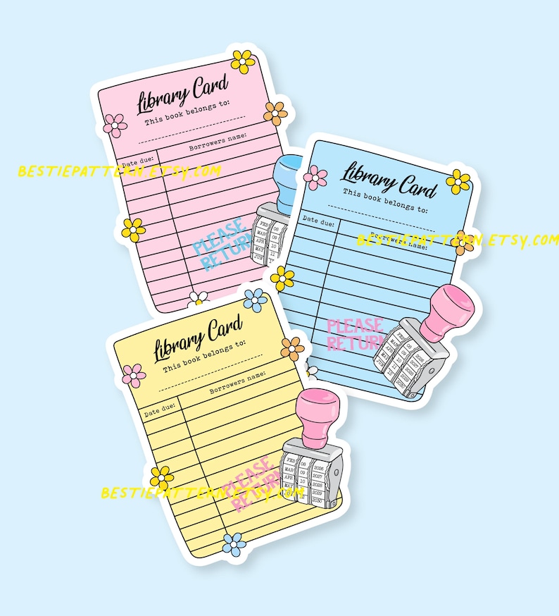 May include: Three colorful library card stickers in pink, blue, and yellow, each with a floral design and the text "Library Card." Each sticker has a date due section and a borrower's name section. A pink stamp is next to each card.