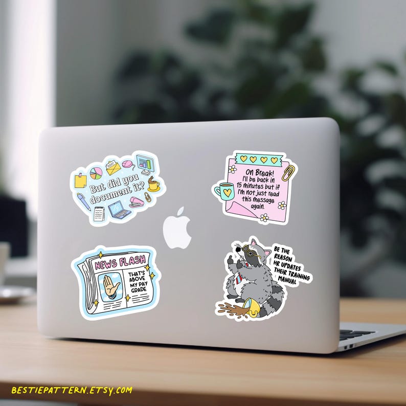 May include: Laptop covered in colorful stickers. Stickers include text: "But did you document it?", "On Break! I'll be back in 15 minutes", "NEWS FLASH That's above my pay grade", and "BE THE REASON HR UPDATES THEIR TRAINING MANUAL".