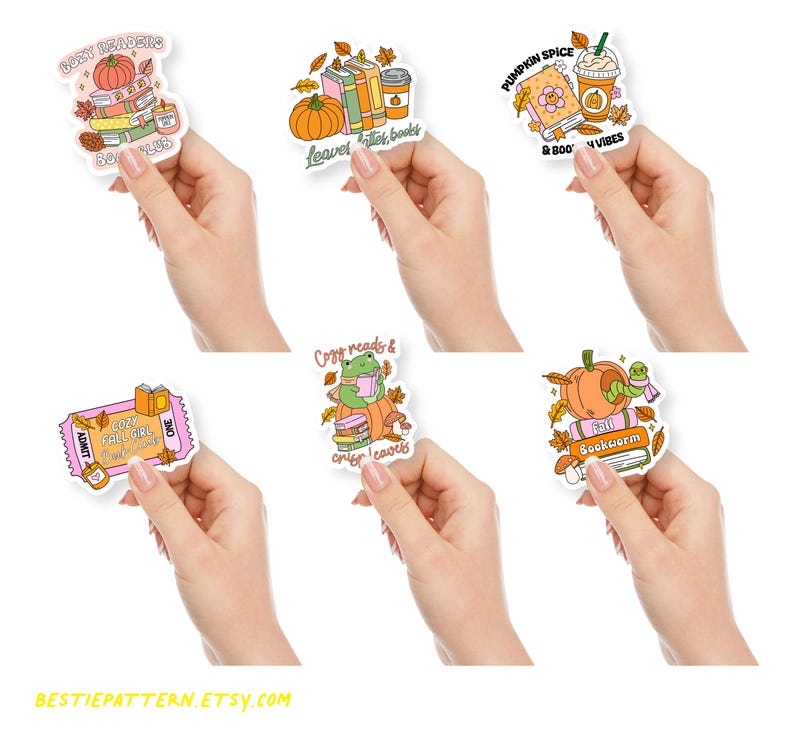 May include: A collection of fall-themed stickers featuring pumpkins, books, coffee, and autumn leaves. The stickers have text like "Cozy Readers," "Leaves, Lattes, Books," and "Pumpkin Spice & Book Vibes." The stickers are held in hands.