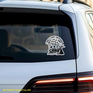 May include: A white car with a black and white sticker on the back window. The sticker says "I run a tight shipwreck".