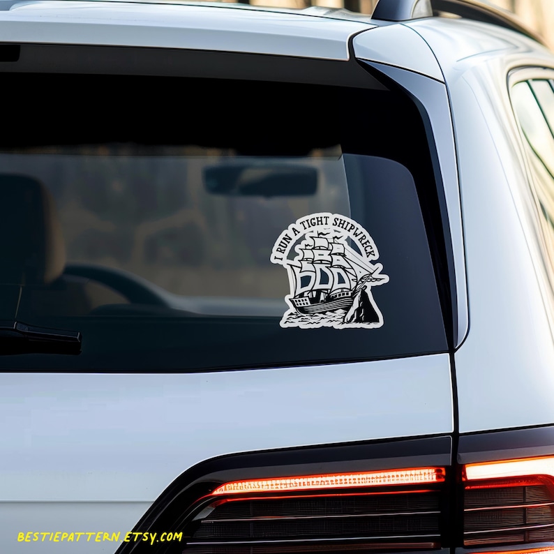 May include: A white car with a black and white sticker on the back window. The sticker says "I run a tight shipwreck".