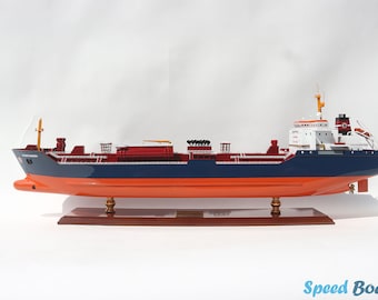 May include: A detailed model of a red and blue cargo ship with a white superstructure. The ship is on a wooden base and has a nameplate that reads "Speed Boat Model".