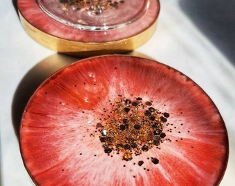 Beautiful round resin coasters... red w/ hints of white, gold glitter and gold edges