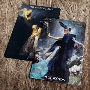 May include: Two tarot cards, one with a dark background and the text "THE HIEROPHANT" and the other with a colorful background and the text "DEPTHS ELASTIKOTTA 9 OF WANDS".