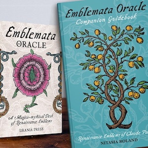 May include: The Emblemata Oracle deck box and companion guidebook. The box is cream with a pink flower, two keys, and snakes. The teal guidebook features a tree with yellow fruit. Text includes Emblemata Oracle, Urania Press, and Nitasia Roland.