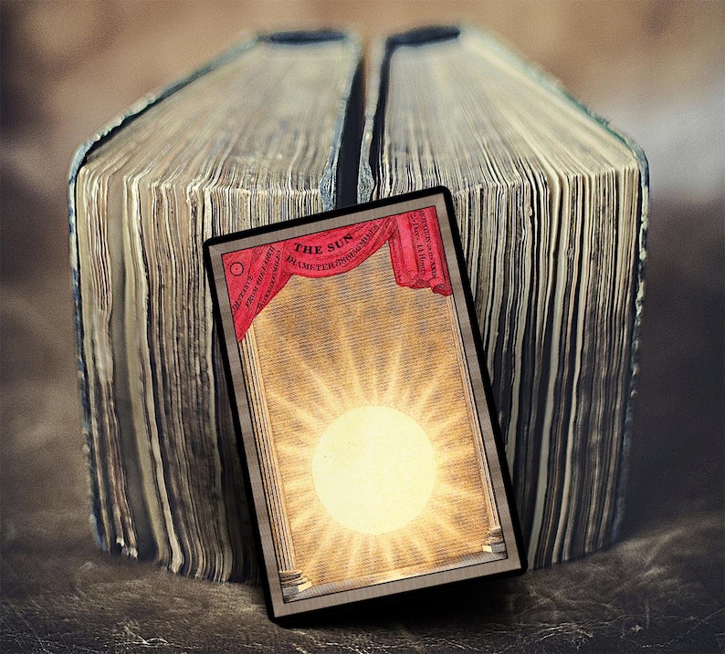 May include: A vintage illustration of the sun, with the text "THE SUN DIAMETER 882,000 MILES" in a red banner at the top. The illustration is framed in a black border and is set against a background of old, worn book pages.
