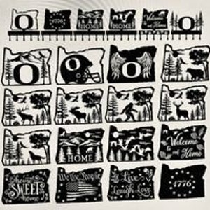 May include: A collection of 16 black metal cutouts of the state of Oregon with various designs. Some designs include a mountain range, a deer, a tree, a football helmet, wings, and the text "Welcome Home".