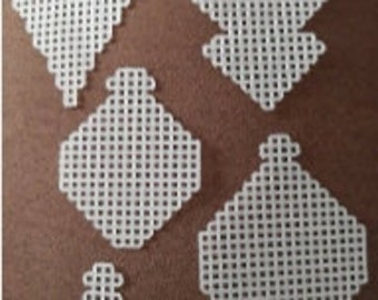 May include: Five white plastic canvas squares of varying sizes, perfect for crafting projects like cross-stitch or needlepoint.