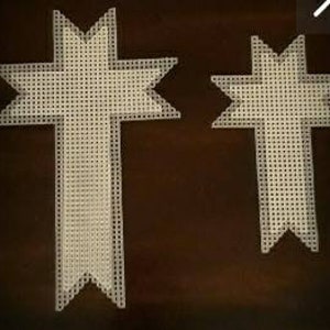 May include: Two white cross-shaped canvas pieces for embroidery or cross-stitch. The larger cross is approximately 12 inches tall and the smaller cross is approximately 6 inches tall.
