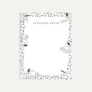 May include: A white notepad with a black and white Dalmatian dog design. The border features black hearts and the dogs are reading books. The text "FETCHING NOTES" is at the top.