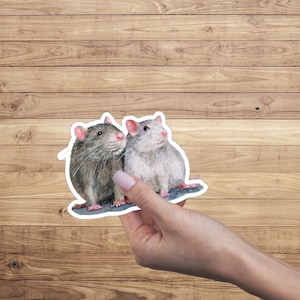May include: Two watercolor painted rats, one gray and one white, are sitting side by side. They are looking to the right and have pink noses.