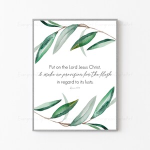 May include: A watercolor print with a green leafy branch design and a white background. The print features the Bible verse "Put on the Lord Jesus Christ, & make no provision for the flesh in regard to its lusts. Romans 13:14."