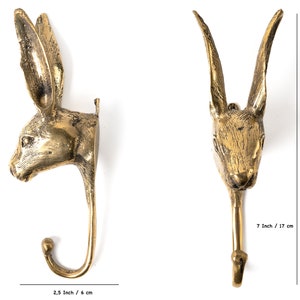 May include: A pair of gold metal rabbit head hooks. The hooks are 7 inches tall and 2.5 inches wide.
