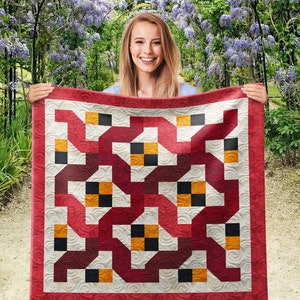 May include: A red, white, and black quilt with a geometric pattern. The quilt is made of squares and rectangles, and the pattern is repeated throughout the quilt.