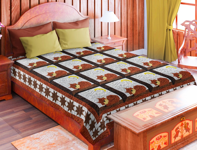 May include: A brown and white quilt with a pattern of squirrels sitting on branches. The quilt is on a bed with a brown wooden headboard and a yellow pillow. The quilt has a brown and white border with stars.