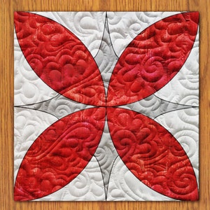 May include: A red and white quilt with a geometric pattern of overlapping circles. The quilt is quilted with a swirling design.